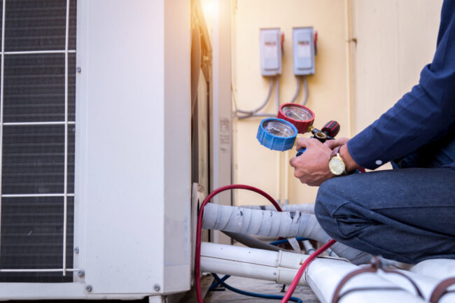 technician-is-checking-air-conditioner-measuring-equipment-filling-air-conditioners HVAC Maintenance